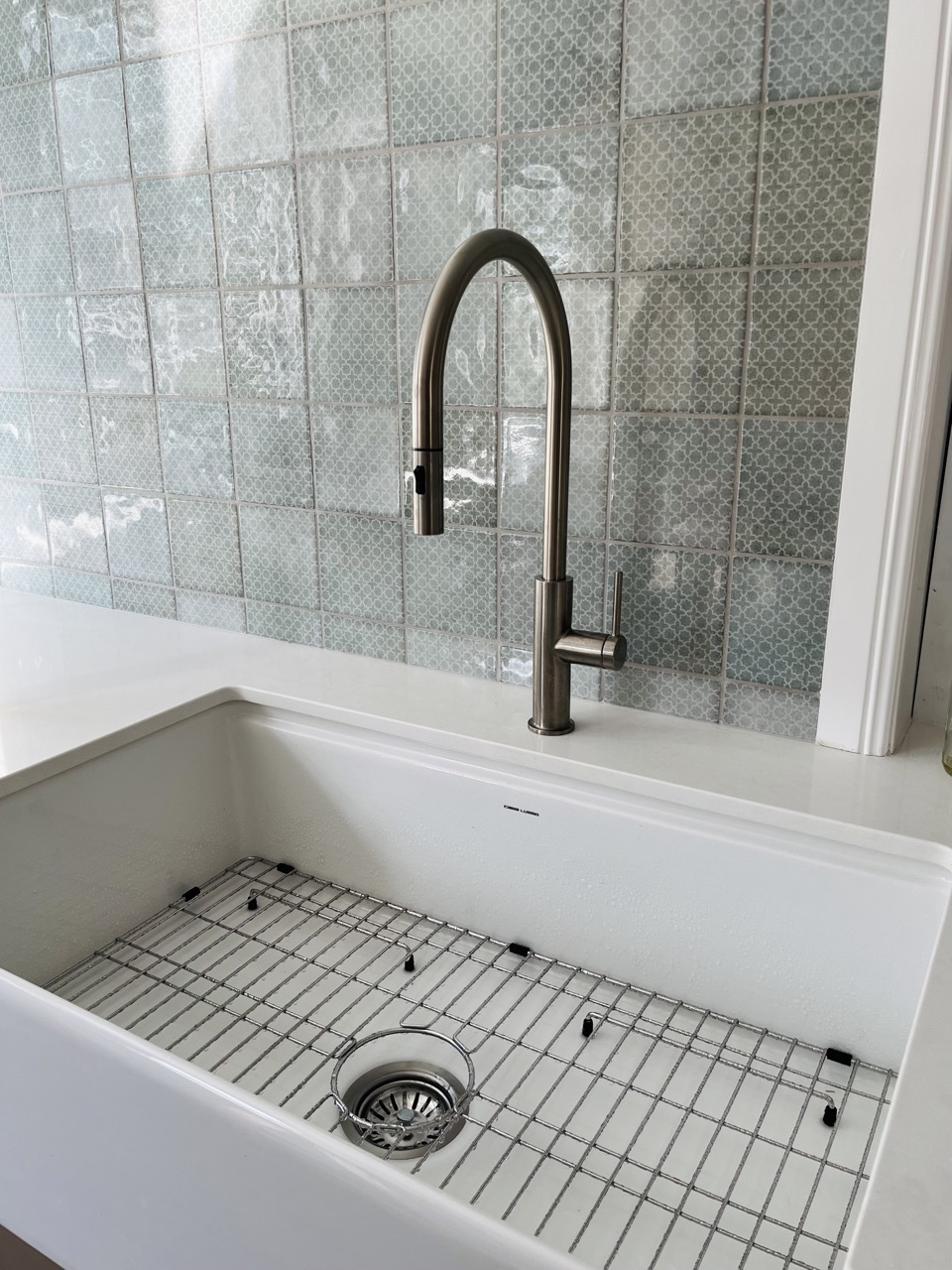 Gunmetal pull-down kitchen mixer over a white butler's sink, installed by Hayne's Plumbing and Gas
